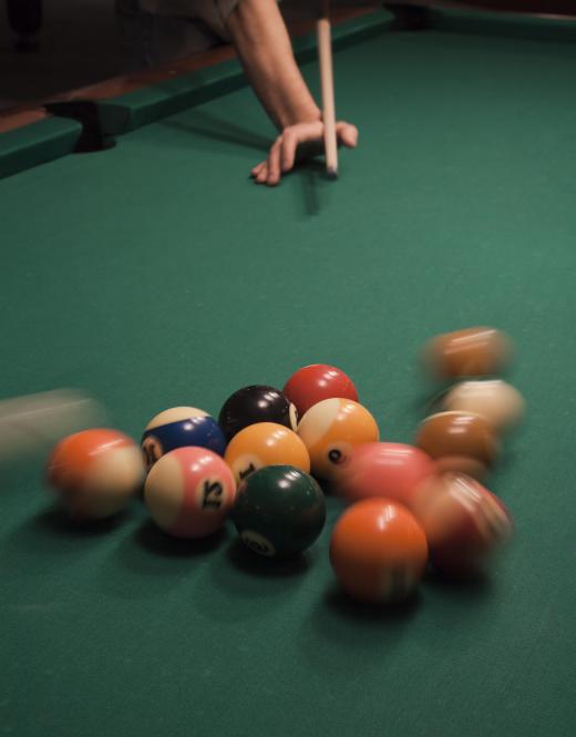 A cue ball striking a stationary group of billiard balls is often used to explain the Compton effect.