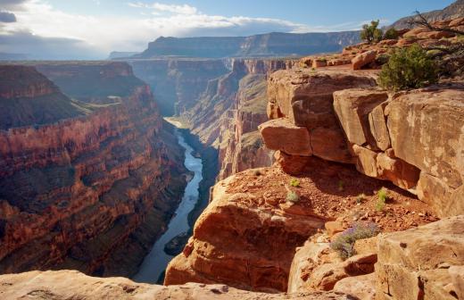 The Grand Canyon is a 1 mile cliff, but is not the steepest in the solar system.