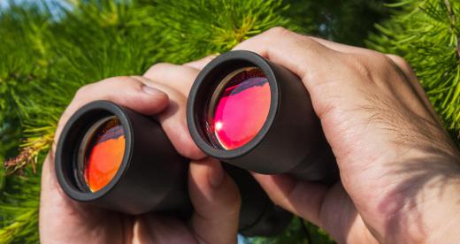 Binoculars allowing people to see distant objects is an example of optical engineering.